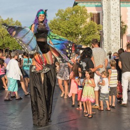 Guests Enjoying Butterfly Stiltwalkers at Broadway at the Beach